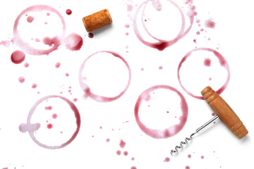 Red wine rings, drops, bung and corkscrew on white background, top view