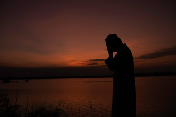 Silhouette of asiam muslim prayer on sunset,Ramadan Festival Concept,bless allah