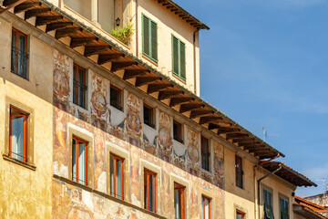 Awesome frescoes on facade of old building in Florence, Italy
