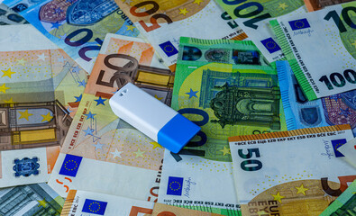 memory usb flash drive on background of euro cash banknotes close up, information security concept