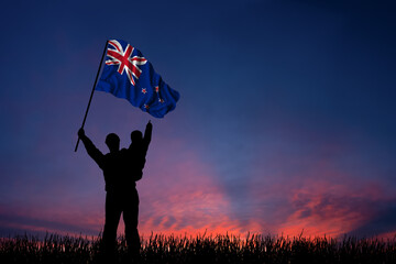 Father and son hold the flag of New Zealand