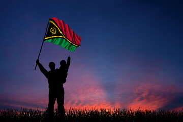 Father and son hold the flag of Vanuatu
