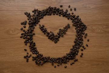 Roasted coffee beans shaped as a clock. Coffee time concept. 