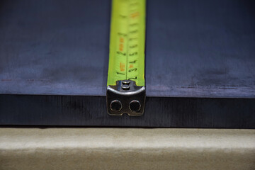 The tape measure is a metal measuring the edge of the corner. resembling the head of a living thing.