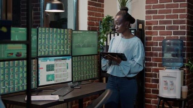 Female investor working with forex exchange on digital tablet, analyzing stock market statistics for capital profit. Financial growth on multi monitors, following hedge fund trade numbers.
