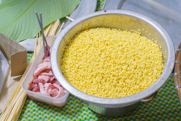 Making chung cake - A traditional food in Tet holiday- Vietnam including green beans, glutinous rice, pork, and pepper wrapped in dong leaves, passed down through generations.