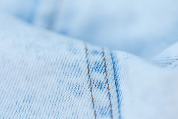 Light blue jeans texture, close-up. Jeans fashion and denim fabric