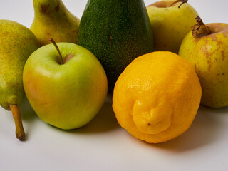 fruits pear apple lemon avocado on white background