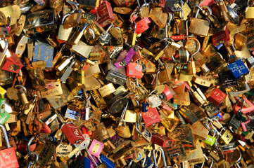 Colorful Love locks on bridge in Paris, France. Ritual of affixing padlocks, as symbol of love, to bridge's fence is spread in Europe from 2000s