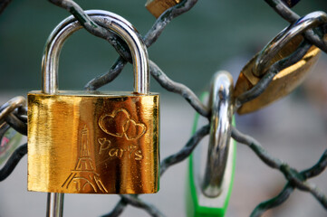 Love lock with Eiffel tower and hearts carving attached to bridge. Paris, France. Romantic vacation concept.
