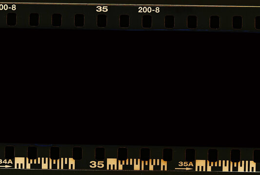 Film scan. Digital number and bezel on film photographs scanned. 35mm film frames strip scanned with signs of usage on bezel. blank old film strip frame background. Retro films border with numbers.