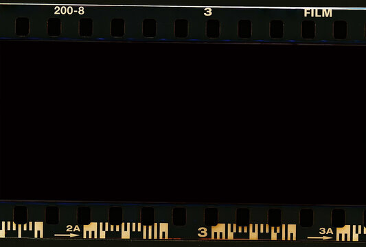 Film scan. Digital number and bezel on film photographs scanned. 35mm film frames strip scanned with signs of usage on bezel. blank old film strip frame background. Retro films border with numbers.