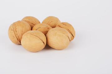 Walnuts on a white background lie in the shape of a circle