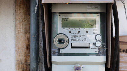 Smart meter on the wall. A close-up digital power meter or smart meter that controls and communicates via RF radio with mobile phones and Wi-Fi devices in real time. Selective focus