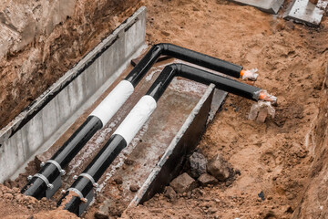 Repair of the water line of the heating main pipe in the ground trench pipeline at the construction site work industry