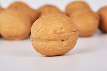 Walnuts on a white background one nut in the foreground