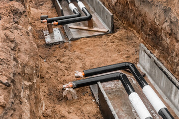 Repair of the water line of the heating main pipe in the ground trench pipeline at the construction site work industry