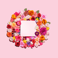 Colorful, bright floral arrangement, paper note, text space. Creative spring layout against pastel pink background. 