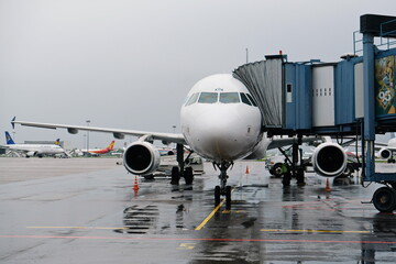Almaty, Kazakhstan - 05.02.2019 : The Air Astana Airline plane is preparing to board passengers and take off from the airport in rainy weather.