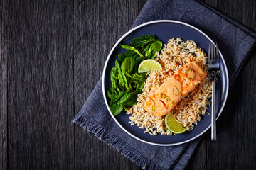 portion of cooked Salmon with rice and greens