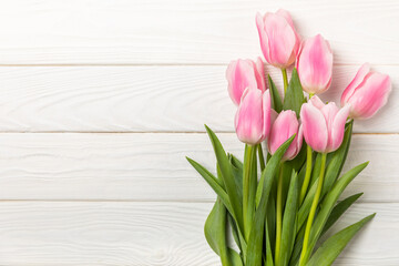 Pink tulips on a white wooden background.Top view. Spring bouquet.Holiday concept.Women's day, Valentine's day,Easter, birthday.Copy space.
