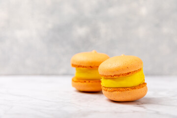 Tasty macarons on a marble background. colorful almond berry cookies.Culinary and cooking concept.Side view.Copy space.