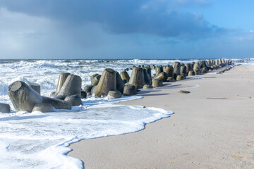 sea landscape with huge waves breaking a poller in Sylt
