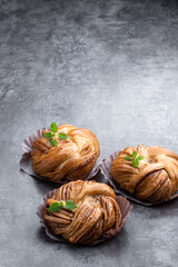 Buns with cinnamon on gray stone background