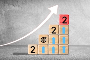 Business New year 2022 concept. Growing up business concept. Wooden cubes
