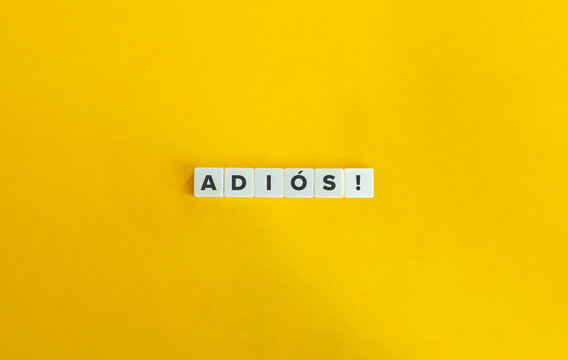 Adios Word on Letter Tiles on Yellow Background. Minimal Aesthetics.