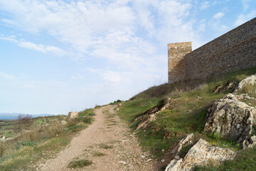Dirt road parallel to the famous Castle of Aracena (Huelva, Spain). A hiking trail in the middle of...