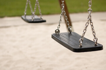 Close up of empty swing at park.