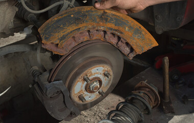 A car brake disc compared to an overheated and ruptured piece of a truck brake disc.