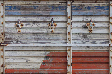 close-up of an old wooden truck body with hooks