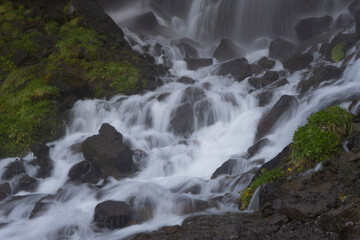 Mountain waterfall in the forest. Waterfall view. Waterfall in mountains. Waterfall pool