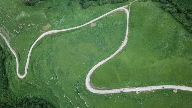 Cars drive along a winding mountain road. Beautiful mountain landscape Elbrus