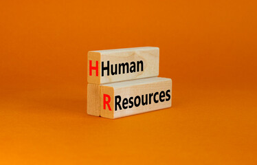 HR Human resources symbol. Concept words HR Human resources on wooden blocks on a beautiful orange table orange background. Business and HR human resources concept.