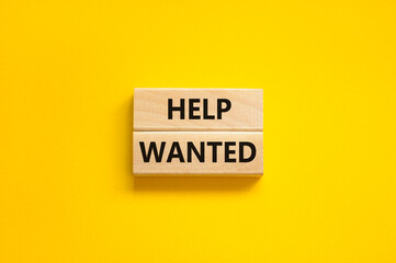 Help wanted and support symbol. Concept words Help wanted on wooden blocks on a beautiful yellow...