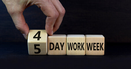 4 or 5 day work week symbol. Businessman turns cubes and changes words 5 day work week to 4 day work week. Beautiful grey background. Copy space. Business and 4 or 5 day work week concept.