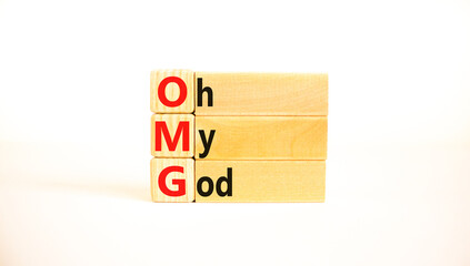 OMG oh my god symbol. Concept words OMG oh my god on wooden blocks on a beautiful white table, white background. Business and OMG oh my god concept. Copy space. - obrazy, fototapety, plakaty
