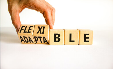 Adaptable or flexible symbol. Businessman turns wooden cubes and changes the word Adaptable to...