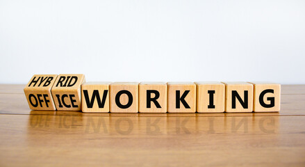 Hybrid or office working symbol. Turned wooden cubes and changed words office working to hybrid...