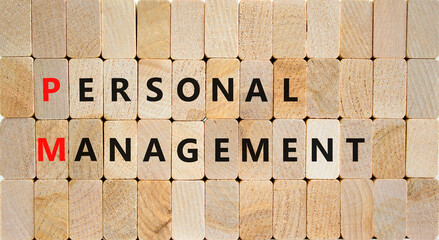 PM Personal management symbol. Concept words PM Personal management on wooden blocks on a beautiful wooden background. Business and PM personal management concept.