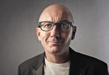 portrait of bald man with glasses