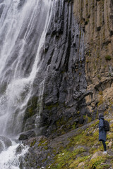 Woman traveller, tourist with a backpack in mountains. Active life concept.
