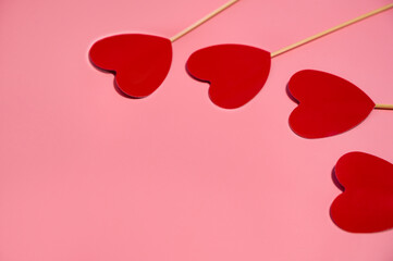 Red paper hearts isolated on pink background.Selective focus