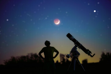 Silhouette of a man, telescope and countryside under the starry skies with young Moon.