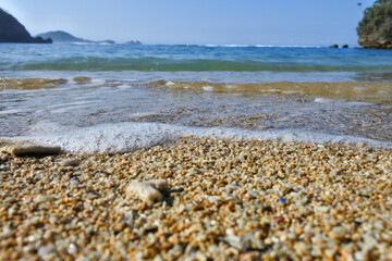wave crash on the shoreline of a beach in indonesia