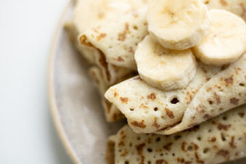 Rolled pancakes with cottage cheese close up . Pancakes with cottage cheese and sour cream