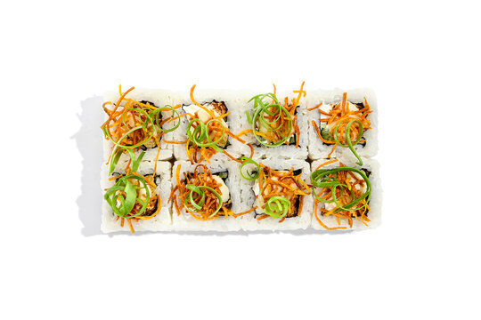 Japanese cuisine - sushi roll with cheese inside, fried carrot and green onion outside isolation on white background. Maki sushi in minimalistic style. Minimal composition with maki sushi.